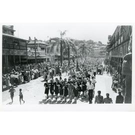 Crowds gather in procession in Flinders Street for the peace announcement, Townsville, 15 August 1945