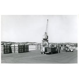 Crane and shipping containers at the Townsville harbour, South Townsville, Townsville, 1975