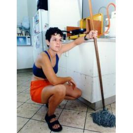 Kate Rees of Albany Road, Hyde Park, Townsville, cleaning up after the flooding of January 1998. 