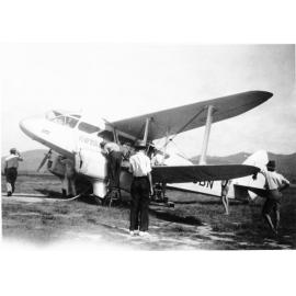 A Dragon Rapide royal mail plane being checked, Ross Plains airfield, c.1939. 