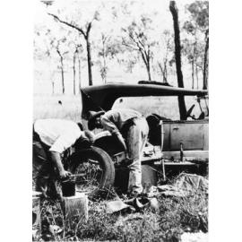 Repairing a car, 1930. 