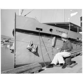 [Boy fishing beside the dredge, "Townsville".] 