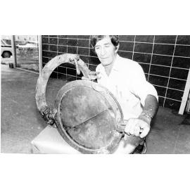 Mr Doug Tarca with a porthole from the Yongala. 