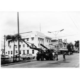Stanchion for first traffic lights being installed, corner Flinders and Stokes streets, 21 June 1966 