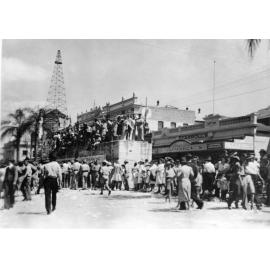 Crowds gather around an air raid shelter in Flinders Street for the peace announcement, Townsville, 15th August, 1945 