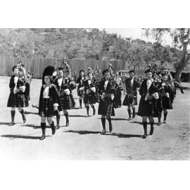 The Townsville Ladies Pipe Band, "Trooping the colours" at the sports reserve, 12 October 1939
