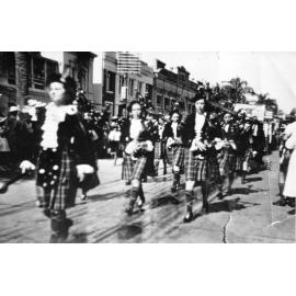 The Townsville Ladies Pipe Band in the May Day march, Flinders Street, 9th May 1940. 