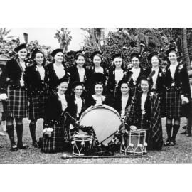 The Townsville Ladies Pipe Band in Anzac Park, after participating in the May Day march, Townsville, 9 May 1940