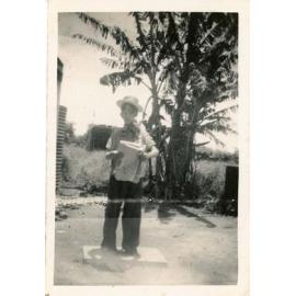 Ernest Matson dressing up for fun, with the cat on his shoulder, ca.1953