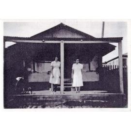 Doreen King and Mrs Sing in front of the shop on Keenan Street, Oonoonba, ca.1953