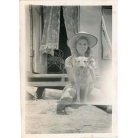 Beatrice Matson with Teddy the dog at her home in Leslie Street, Oonoonba, Townsville, ca.1953