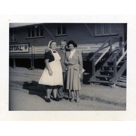 Mrs Olszewski and Mr & Mrs Cameron standing in front of the hospital building at the Stuart Immigration Holding Centre, Townsville, ca.1952
