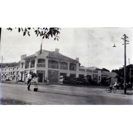 Jeffery collection : Photographer in front of the fire station, corner of Walker and Stokes Streets, Townsville