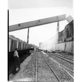 Hosing down after the fire at the Townsville Bulk Sugar Terminal. 