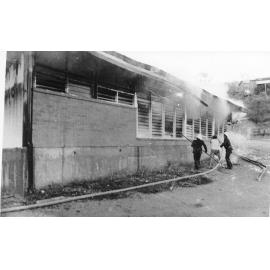 Firefighters attending the fire at the Endeavour Foundation workshop, Landsborough Street, North Ward, Townsville, 27 May 1974