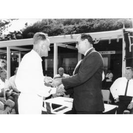 Townsville Mayor, Alderman Angus Smith shakes hands with Les Finnerty at the official opening of the Picnic Bay Surf Life Saving Club clubhouse, 4th December, 1966. 