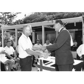 Townsville Mayor, Alderman Angus Smith shakes hands with life member, Keith Anderson at the official opening of the Picnic Bay Surf Life Saving Club clubhouse, Magnetic Island, 4 December 1966