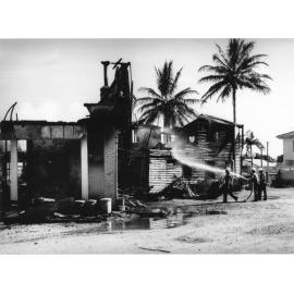 Firemen attending the fire at the Crown Hotel, Palmer Street, South Townsville, 17 January 1971