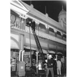 Firemen attending the fire at the Town Hall and Market Reserve buildings, Townsville, 26th July, 1969 