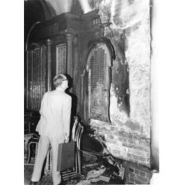 Townsville Mayor, Alderman Harold Phillips, inspects fire damage to the honour boards. 