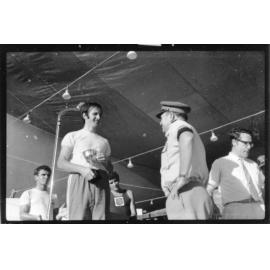 Mike Phillips, winner of the Townsville Pacific Festival "King of the Castle" run, in 34 minutes and 7 seconds, receives his trophy, 1972