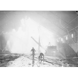 Firefighters attending the fire at the Townsville Bulk Sugar Terminal. 