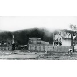 Firefighters attending the fire at the Endeavour Foundation workshop, Landsborough Street, North Ward, Townsville, 27th May, 1974