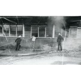 Firefighters attending the fire at the Endeavour Foundation workshop, Landsborough Street, North Ward, Townsville, 27th May, 1974