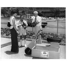 The NORQEB battery electric scout scooter, with Mayor Perc Tucker and Reg Taylor from the NORQEB Marketing Department, Townsville, circa 1979