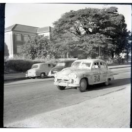 Car 38 in the Redex Trial 1955 on Ingham Road, Townsville. West End Primary School is in the background