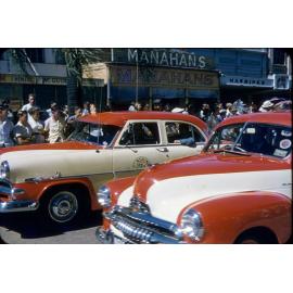 Sunshine Taxis carrying veterans unable to march, ANZAC Day march, Townsville, 25 April 1957
