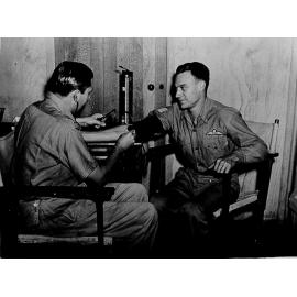 Mount Spec, RAAF Convalescent Depot with Flight Lieutenant James Conquest taking blood pressure of Flight Sergeant Ben Renew, 1944 