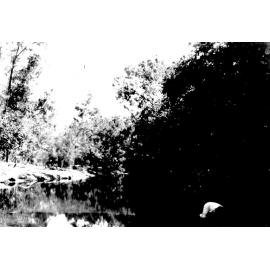 James Kelso collecting a billy of water at Riverview Creek on the road to Ingham, ca 1927 