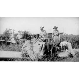 G. Mason, P. Mathiesen, S. White, A. Butcher, R. Harrison, with destroyed aircraft at Madang Strip, ca 1940