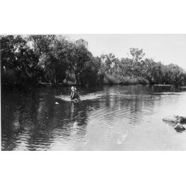 Man riding horse, fording the Cloncurry River, ca 1940 