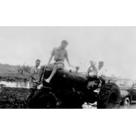 Three men using a tractor to extricate bogged utility, 5 miles outside of Cloncurry, ca 1940 