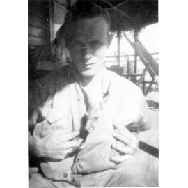 Joe Grice with a baby kangaroo, ca 1940 
