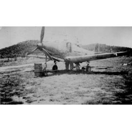 Air cobra aircraft in a field with drum, ca 1940 