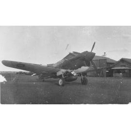 Kitty Hawk - P47 aircraft in front of hangars at airstrip, ca 1940 