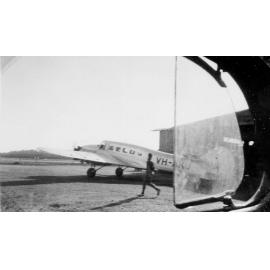 Lockheed Electra aircraft in front of hangar, ca 1940 