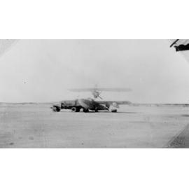 Walrus aircraft in airfield with truck, ca 1940 