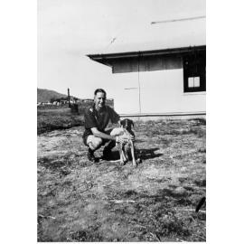 Man in Townsville military (airforce) sports uniform, with troop mascot, LAC Bluey, ca 1940