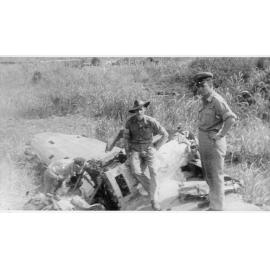 Jim Darmony at Madang Airstrip with downed Zero aircraft, ca 1940 