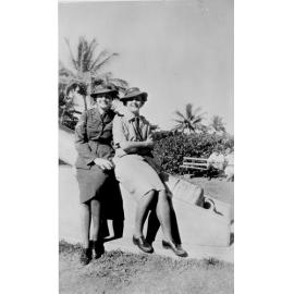Two servicewomen seated on gun at the Strand, Townsville, 1943 