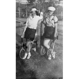 Jane and Doris Kelso at tennis with tennis court in background, ca 1938 