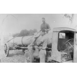 Arthur and Ernie Kelso, transporting lumber on old International truck, ca 1940 