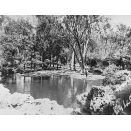 Dick Kelso with dog at Harts Water Hole, behind Round Mount, ca 1940 