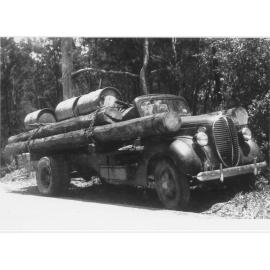 Truck bearing timber and fuel drums for personal use from hidden valley, ca 1930 