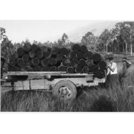 Timber cutters loading wood for firewood onto a truck, ca 1930 