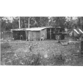 Timber cutter's camp with huts, tents and dog, Hidden Valley, ca 1930 